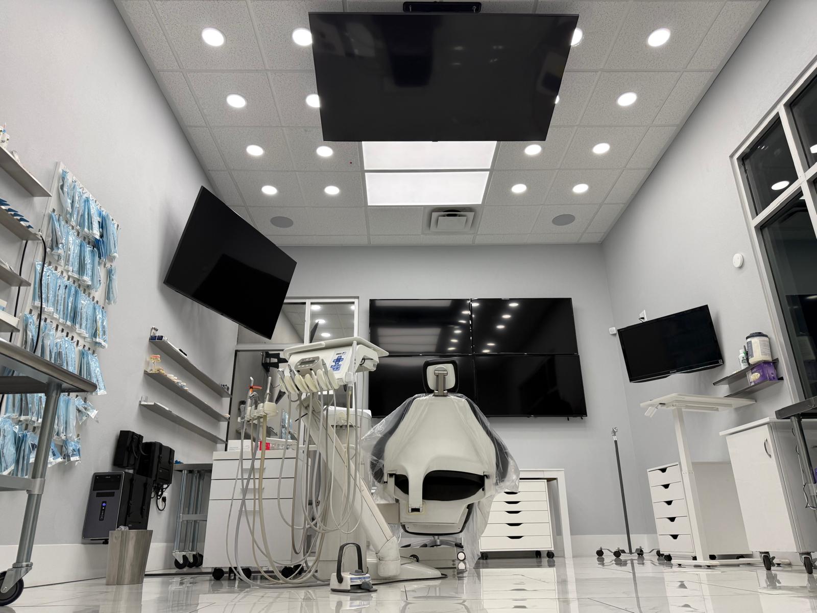 State-of-the-art dental operatory at Pleasant-Smiles in Henderson, NV, with overhead monitors and modern treatment equipment