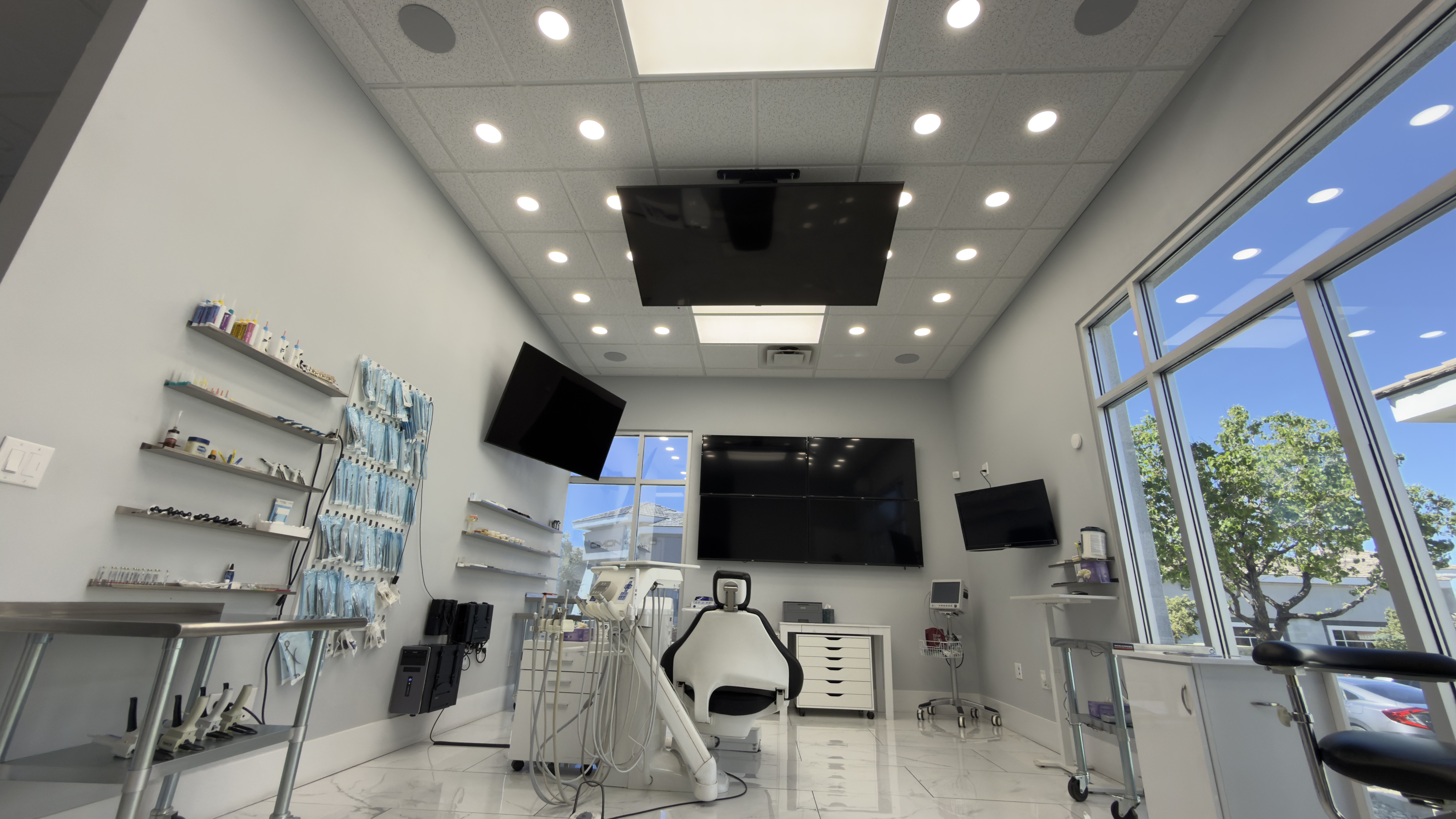 Modern dental treatment room with patient chair and equipment